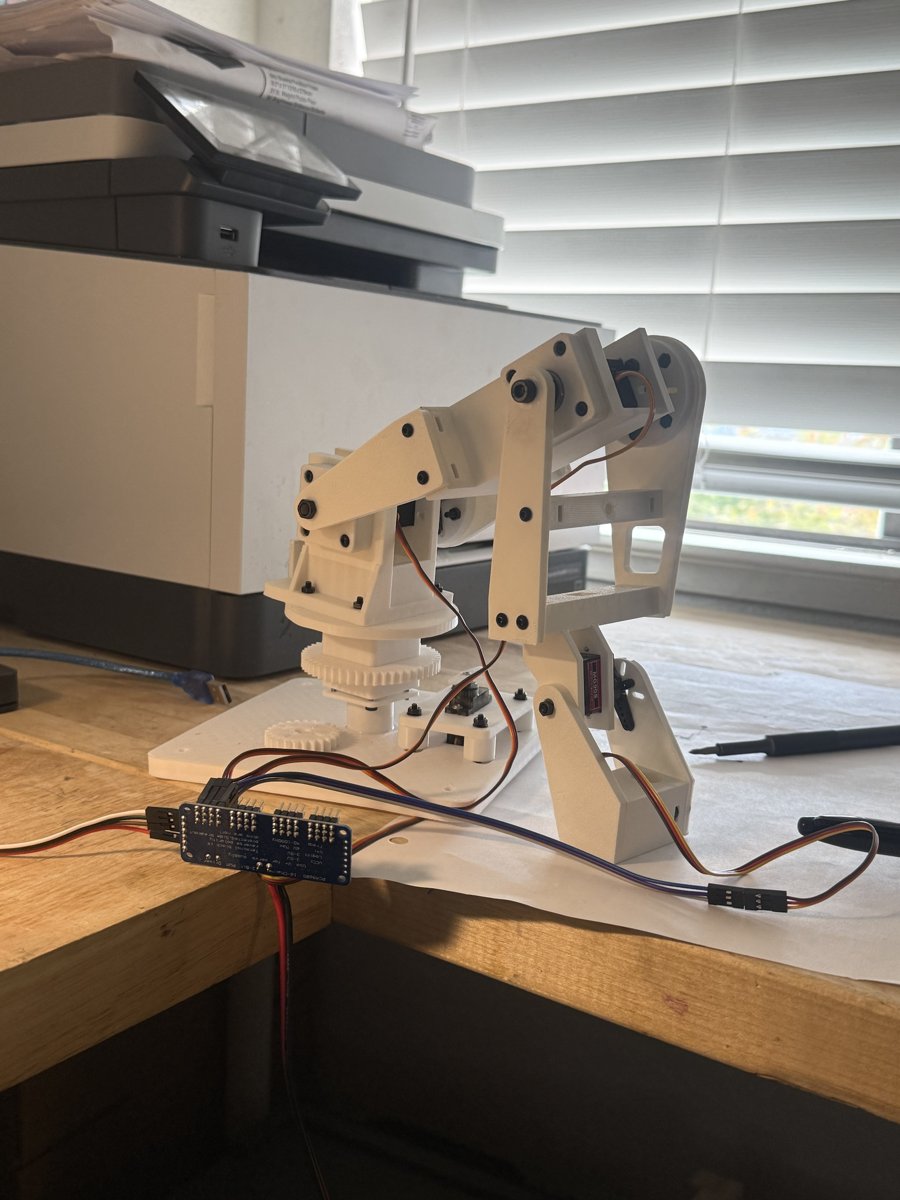 The assembled Scribbot arm on a desk, wired to its PCA9685 servo driver